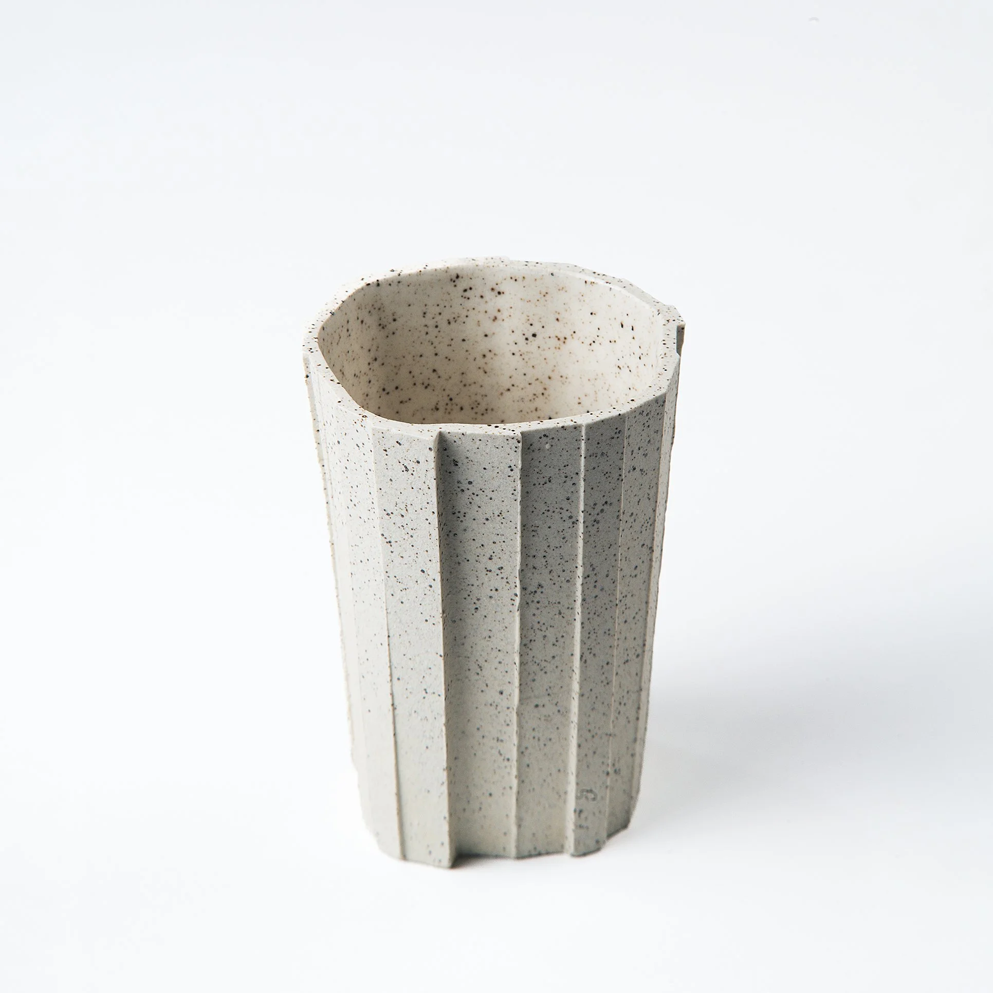 Handmade brutalist faceted ceramic tumbler, speckled white stoneware, by Lea & Nicolas