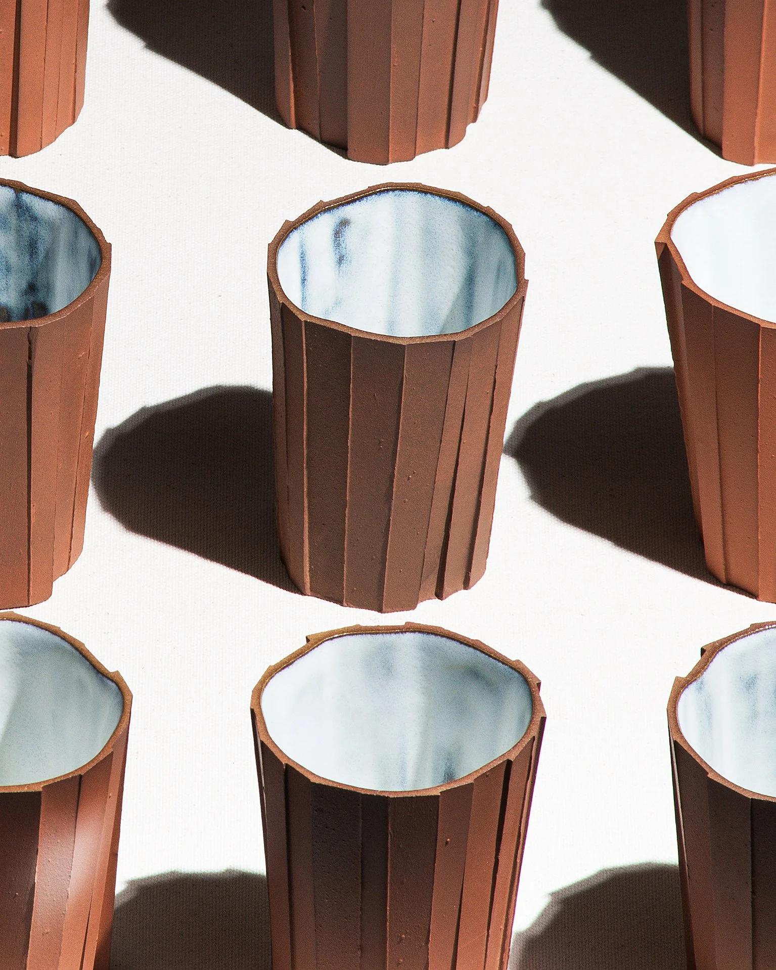 Handmade brutalist faceted ceramic tumbler, unglazed red stoneware, by Lea & Nicolas