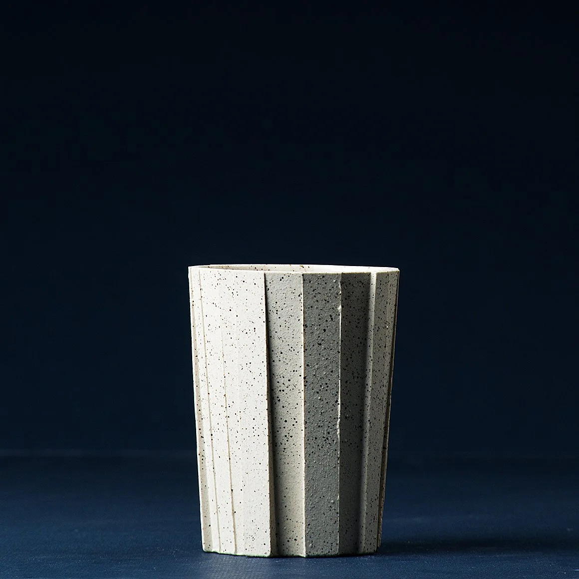 Handmade brutalist faceted ceramic tumbler, speckled white stoneware, by Lea & Nicolas