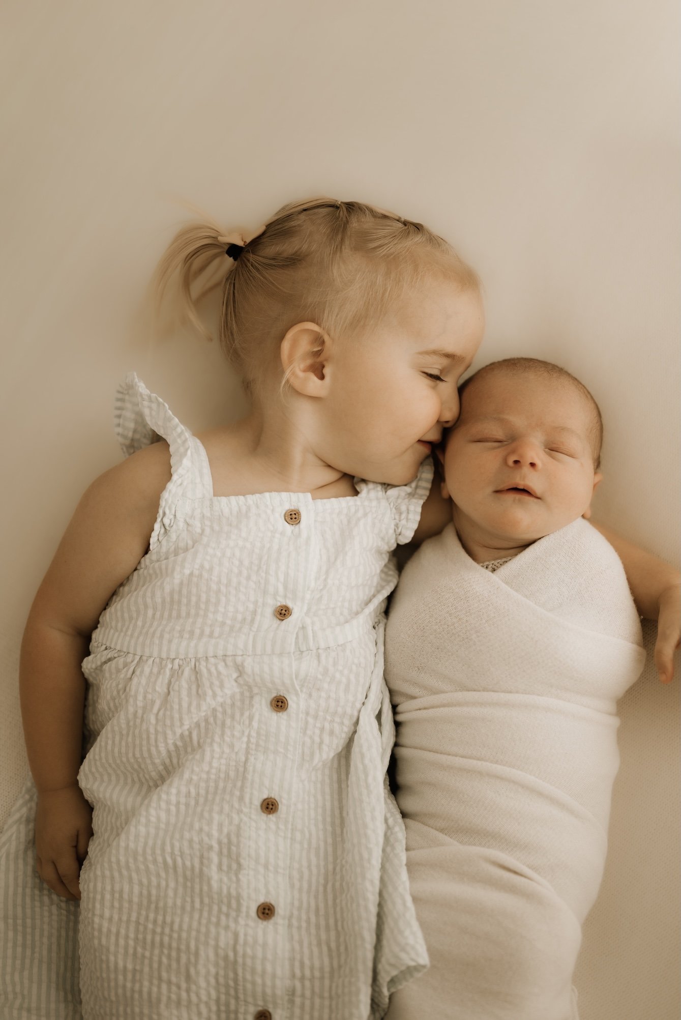 Siblings during a newborn photo shoot. Timeless, dreamy, calm, effortless newborn photography. For the mother who wants to remember it all, she wants to remember how small her baby was in the beginning. Echuca Newborn Photographer. 