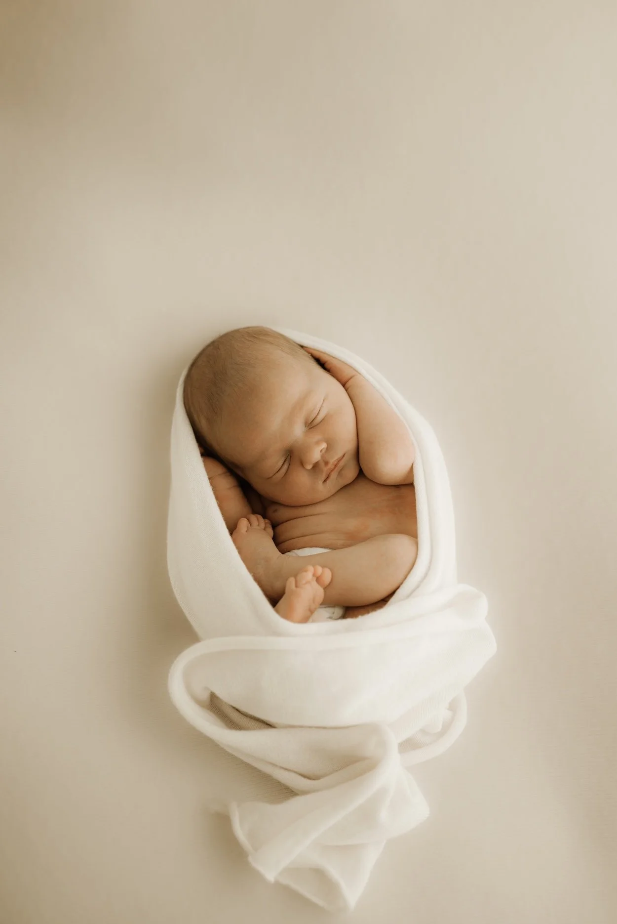 A newborn baby during a newborn photo shoot. Timeless, dreamy, calm, effortless newborn photography. For the mother who wants to remember it all, she wants to remember how small her baby was in the beginning. Echuca Newborn Photographer.