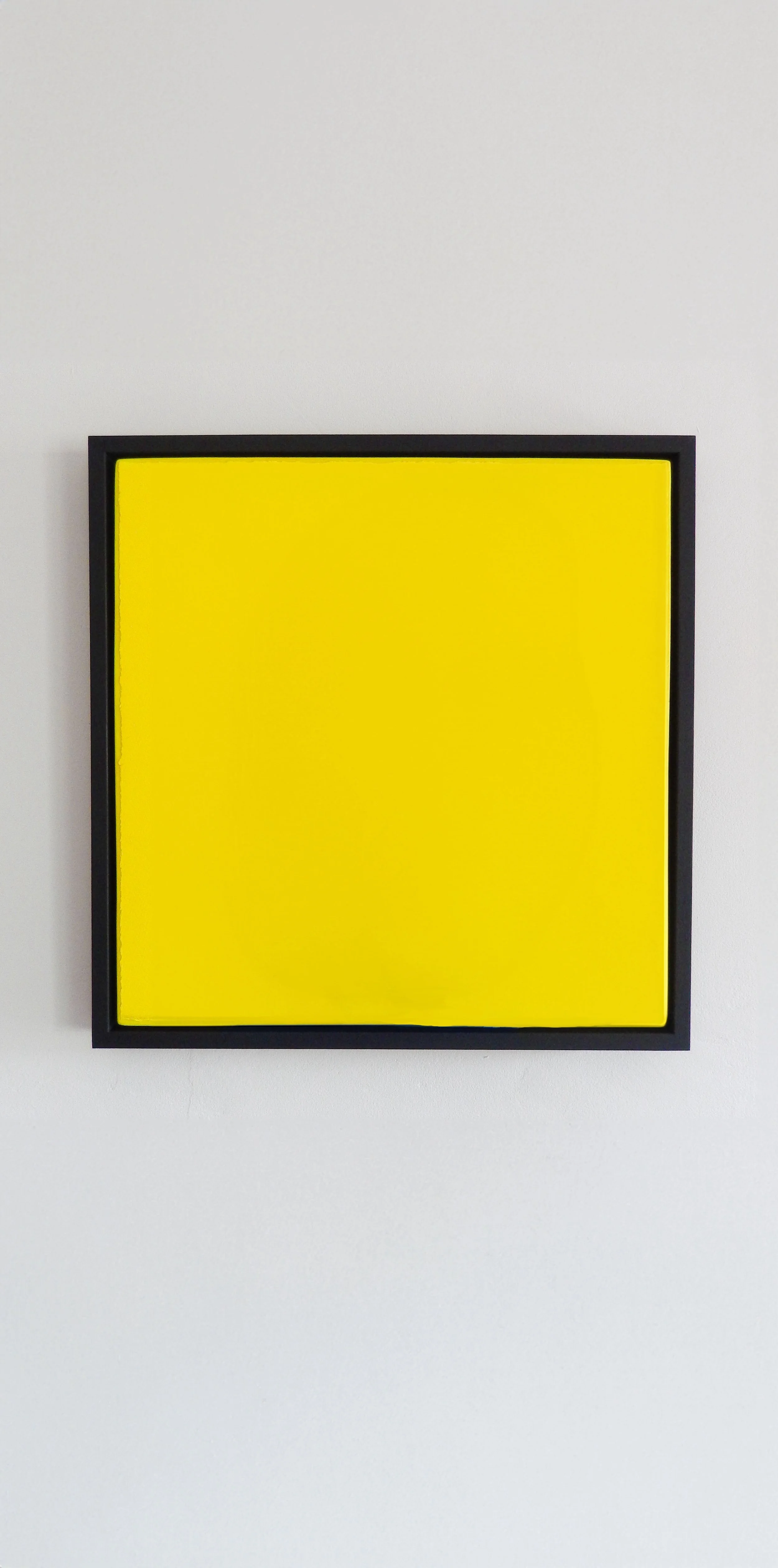 digitally manipulated yellow-coloured square-shaped silkscreen artwork in a black frame
