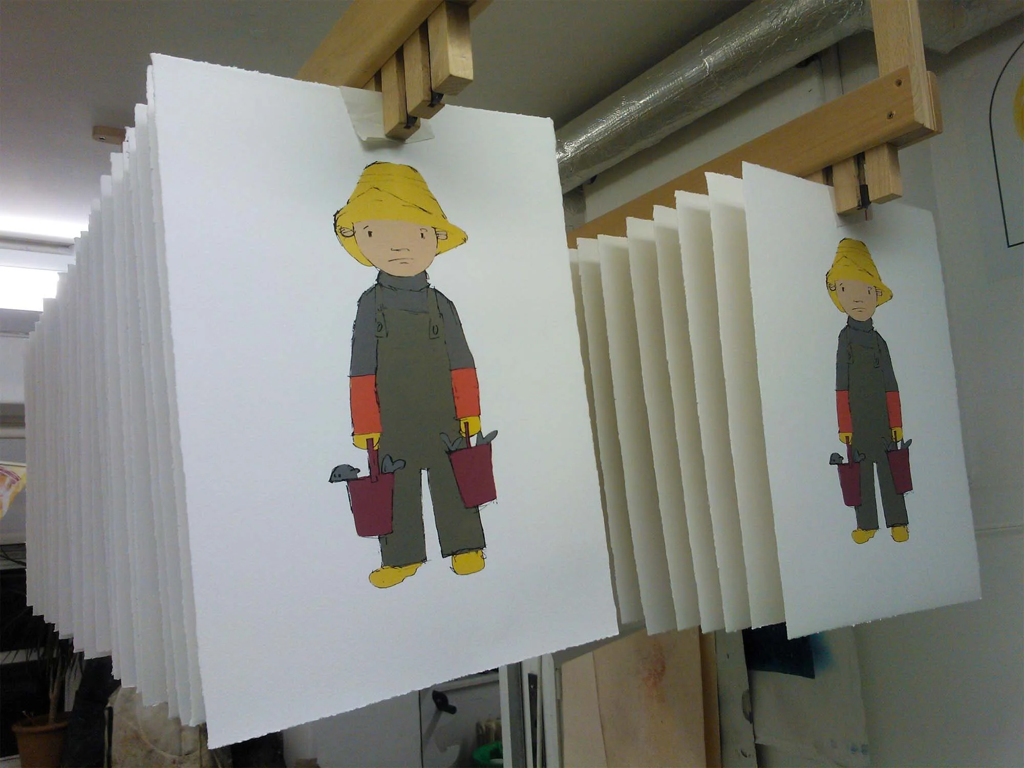 04-Boy-with-buckets-of-fish-on-paper-drying.jpg
