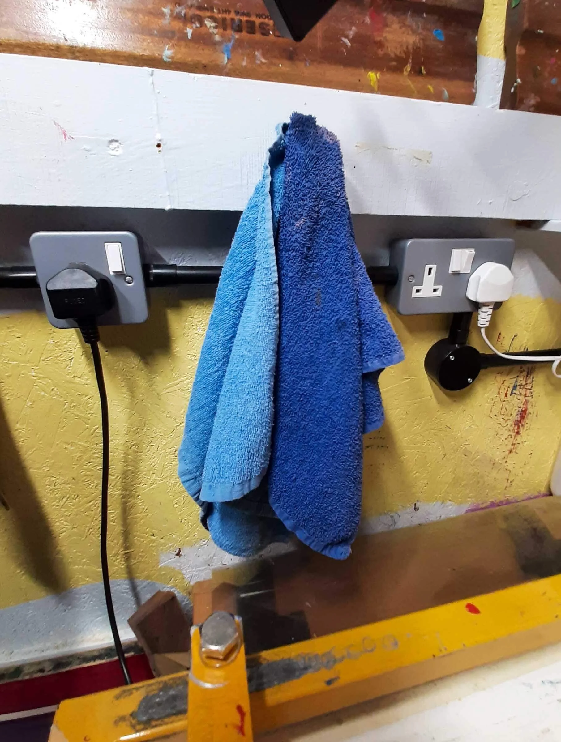 A wall socket beside a vacuum table in a print studio, used to power the vacuum and heater.