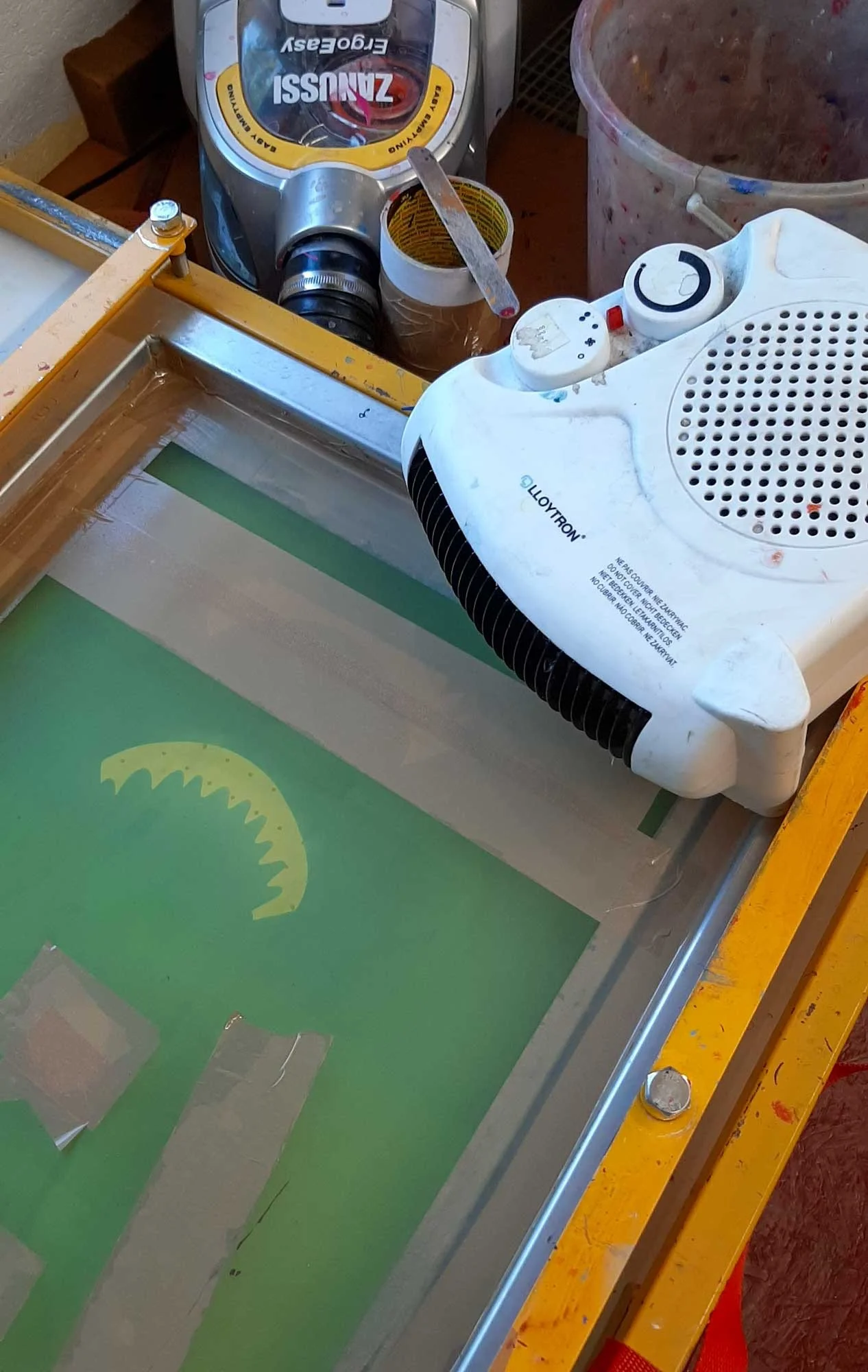 Silkscreen frame with parcel tape sealing edges and masking off unwanted print areas.