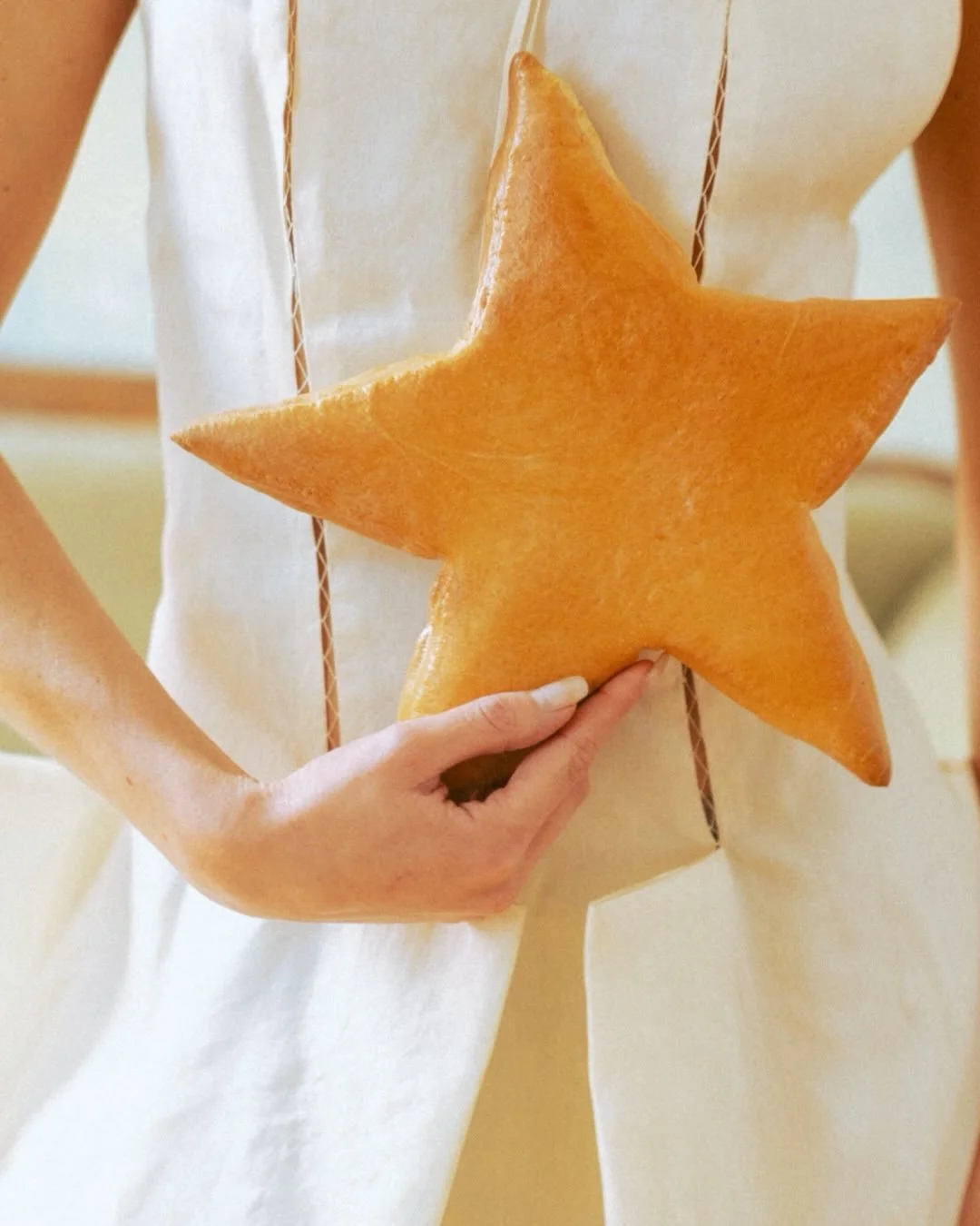 Think celestial, a little unconventional, and very much anti-bride. The bouquet is the real star of the show: no flowers, just a cluster of bread baked into little stars.

And for the cake, we&rsquo;re skipping tiers and going with a handbag covered 