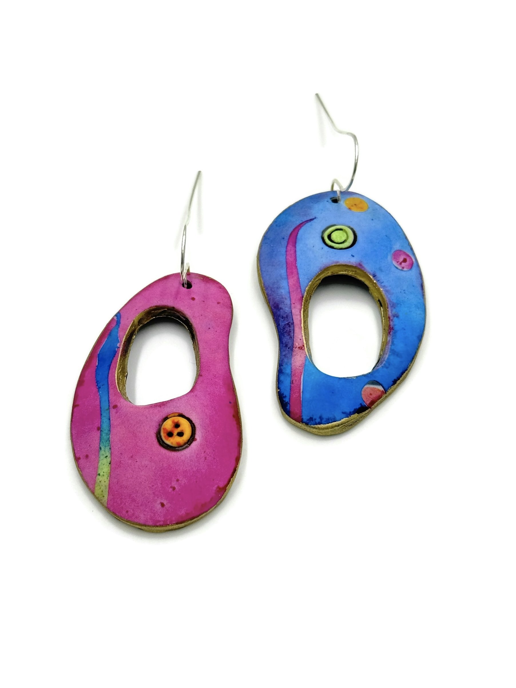 Mismatched pink and blue polymer clay earrings with sculptural cutout shapes and silver plated earwires