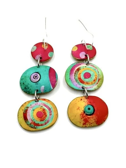 Handmade colorful drop earrings with dots and circular patterns in pink, turquoise, and yellow tones