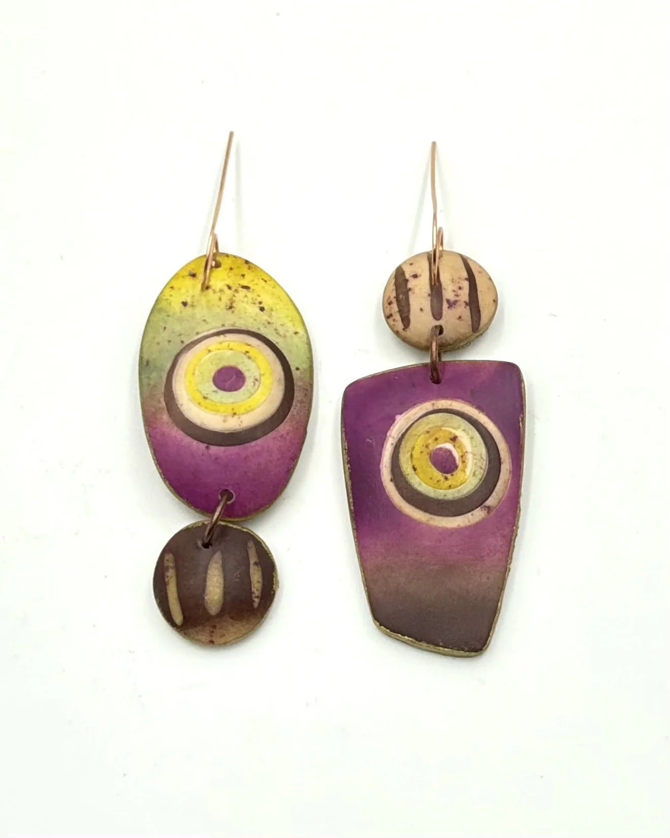 Handmade asymmetrical drop earrings in mustard yellow, olive, plum, and brown tones with circular motifs and painterly textures