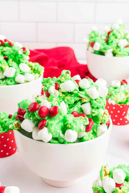 Green Grinch popcorn with festive sprinkles, easy Christmas movie night snack.