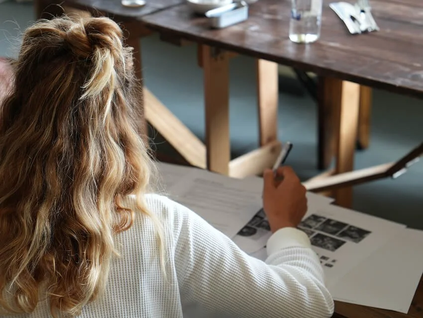 image of a woman creating a shot list in a photography studio