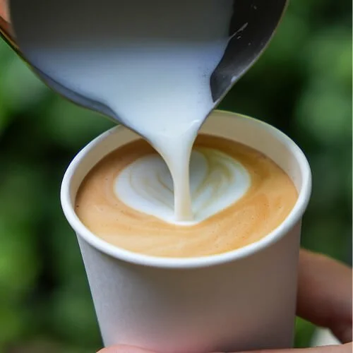 Craft coffee being poured into a vegware takeaway coffee cup.