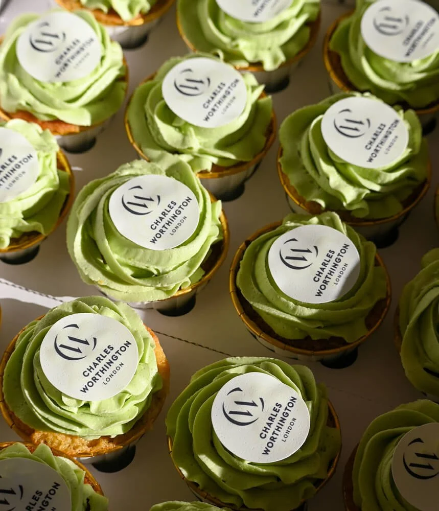 10 Green piped buttercream cupcakes with rice paper Charles Worthington Branding on top