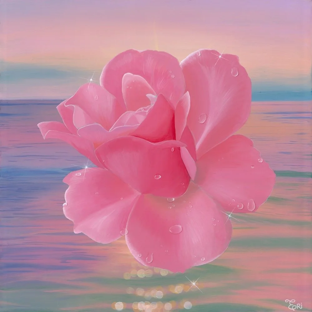 A close-up of a pink flower, possibly a rose, floating on water with gentle ripples, set against a pastel-colored sky at sunrise or sunset, with water droplets on its petals and sparkling highlights.