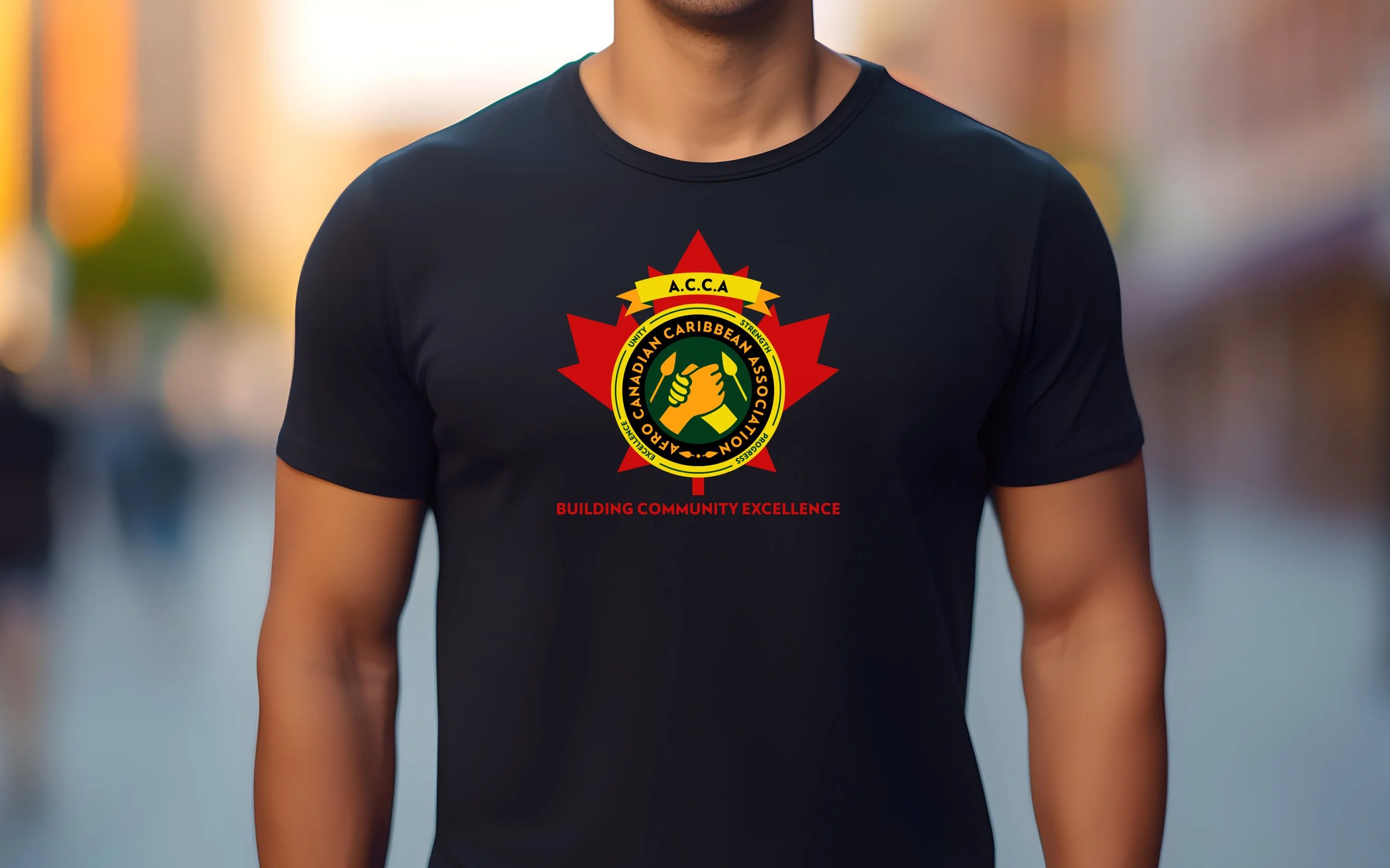 Person wearing a black T-shirt with a logo featuring a maple leaf and two hands shaking inside a circle, labeled "Canadian Caribbean Association" and "Building Community Excellence."