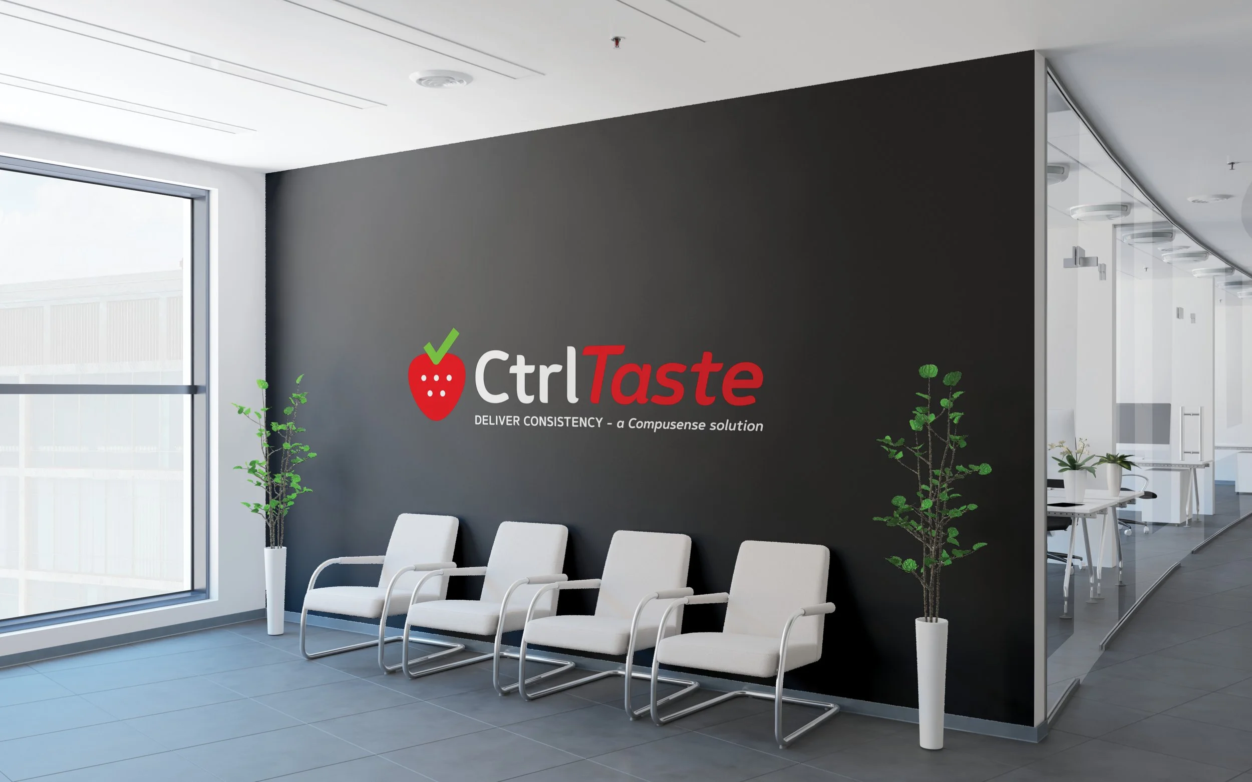 Modern office lobby with a black wall displaying the CtrlTaste logo, white chairs, and potted plants.