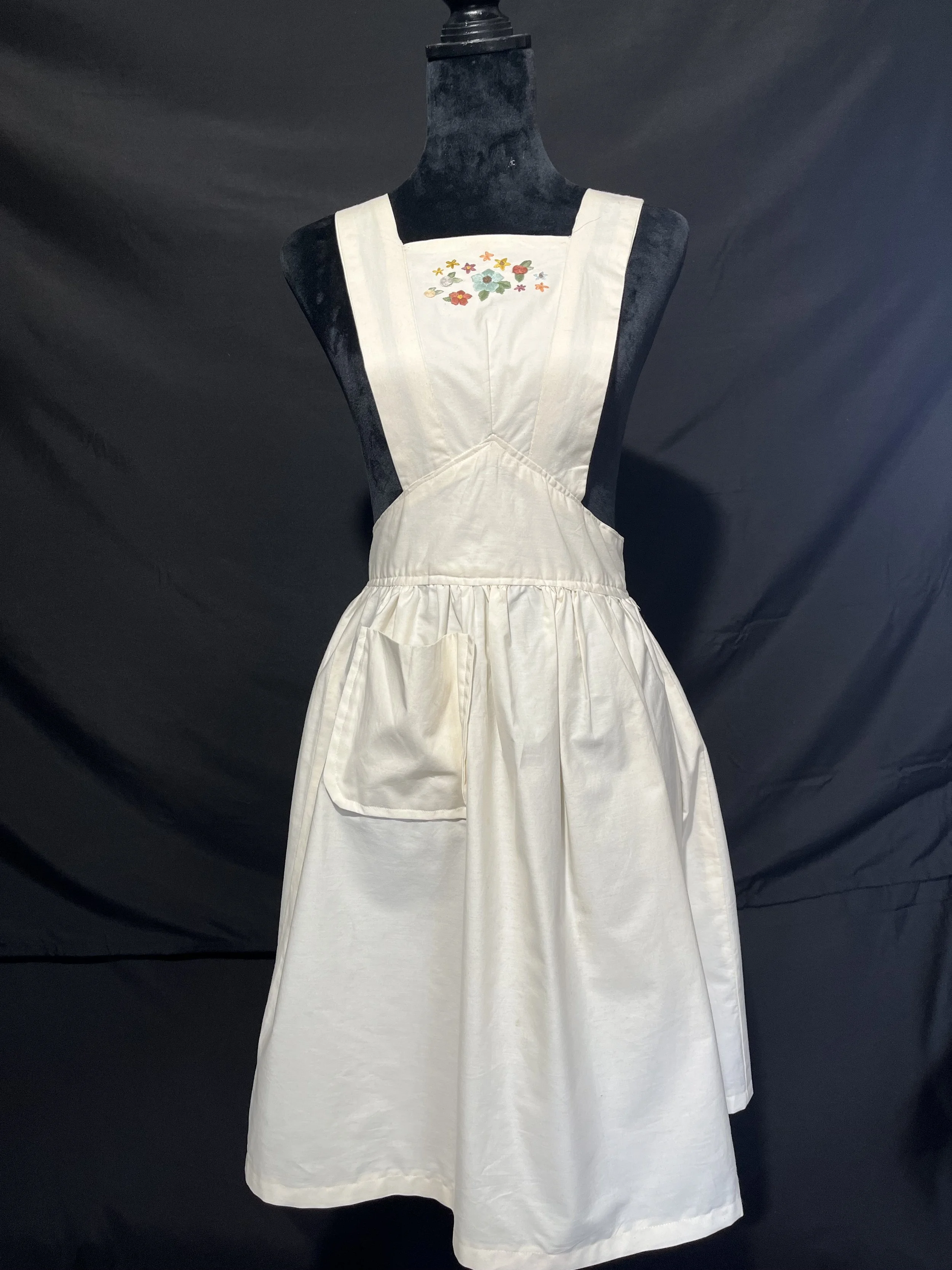 Muslin apron made from vintage pattern with floral hand embroidery.