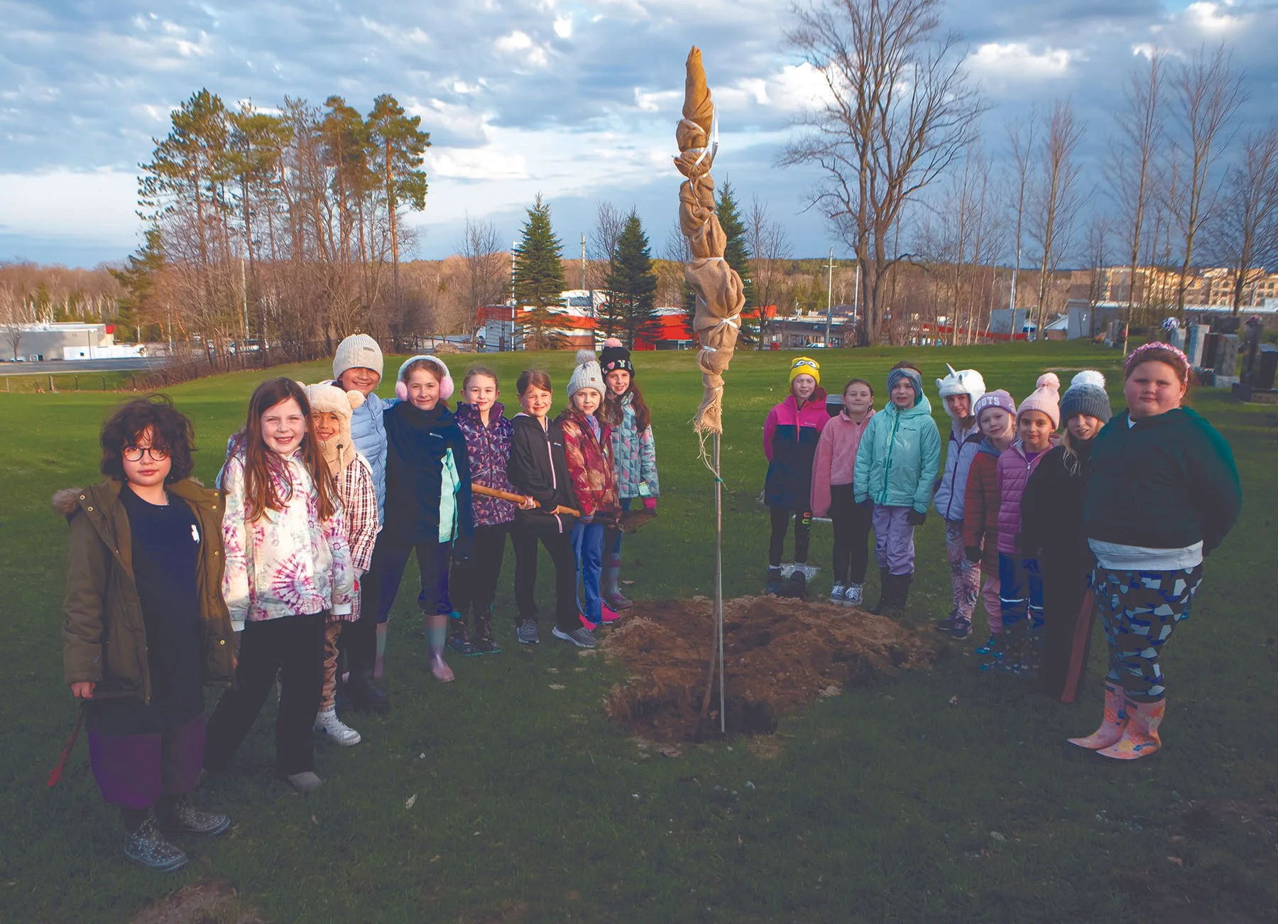 Embers plant tree for Earth Day