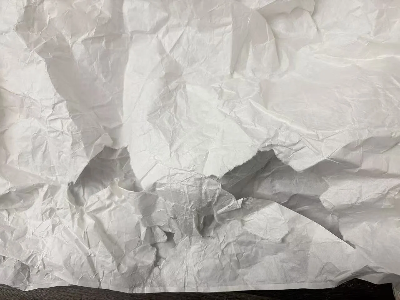 Torn lower hem of the white washi paper costume after the St. Andrew’s Playground performance, showing large ruptures caused when the paper adhered to snow and tore away during movement. Photograph by Yuting Zhou, 2026.
