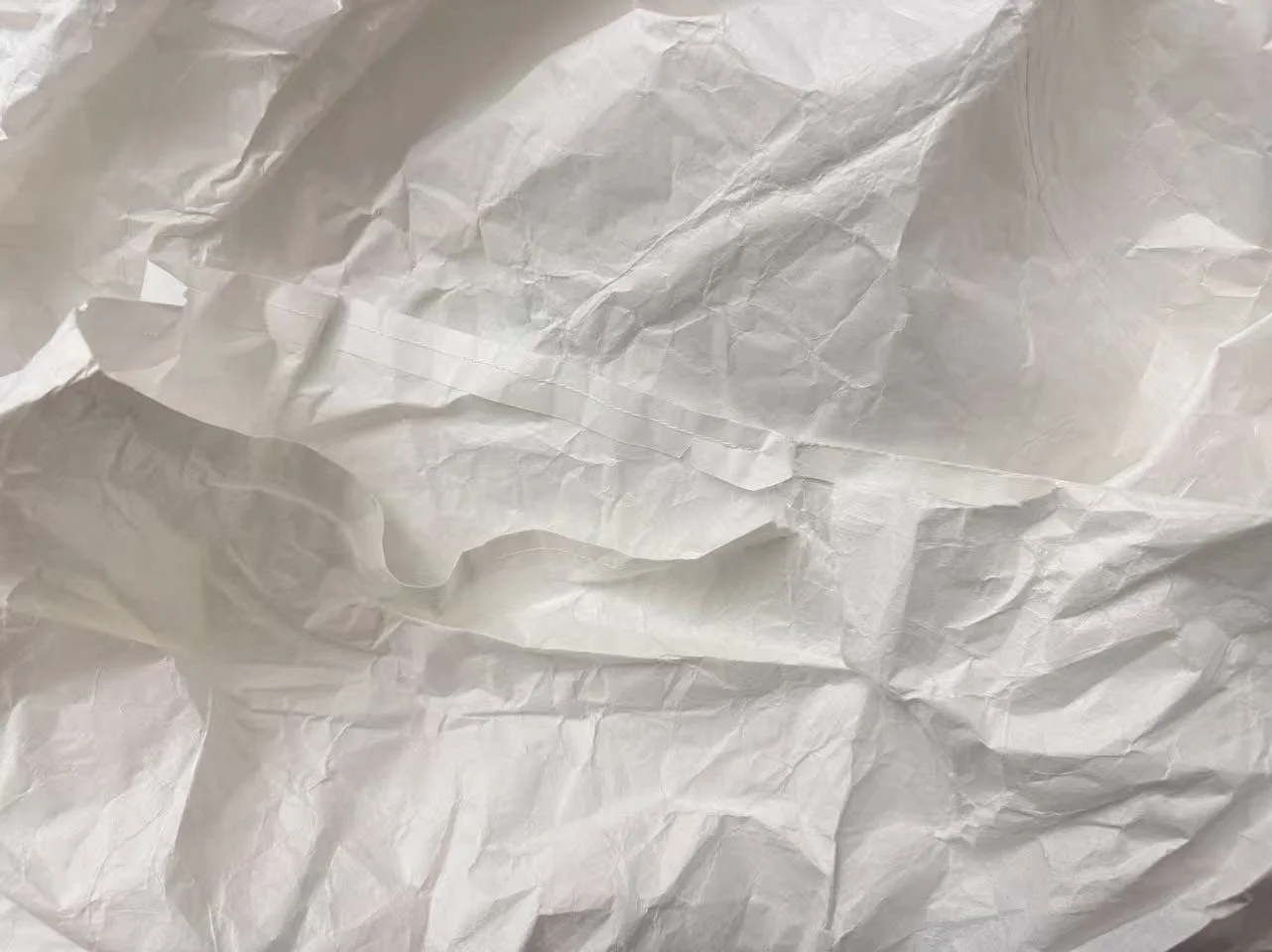 Tear at the armhole of the white washi paper costume after the first and second performances, showing structural damage caused by repeated movement and strain. Photograph by Yuting Zhou, 2026.
