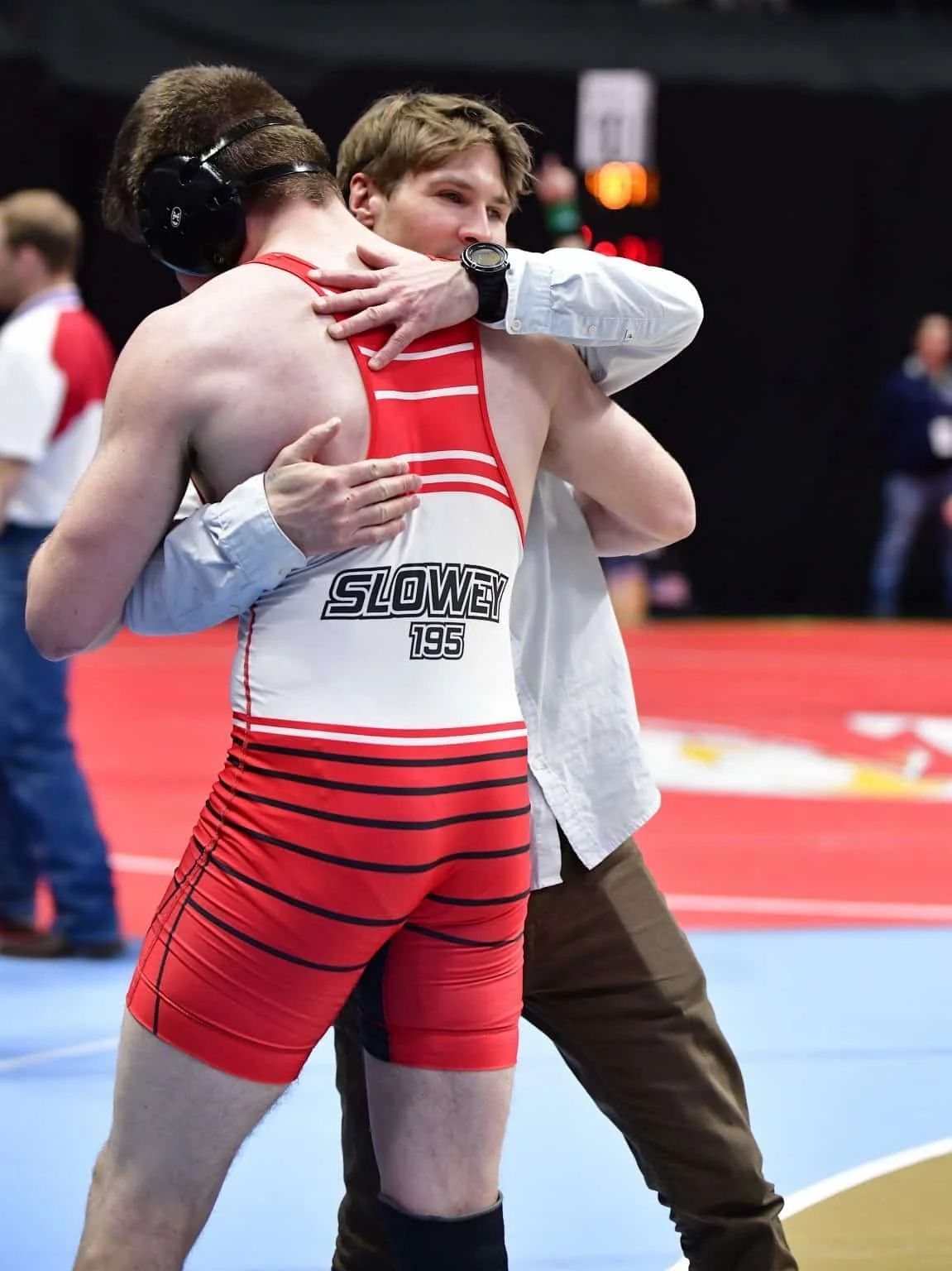 Jordan Bonifas hugging a wrestler he coached after a match