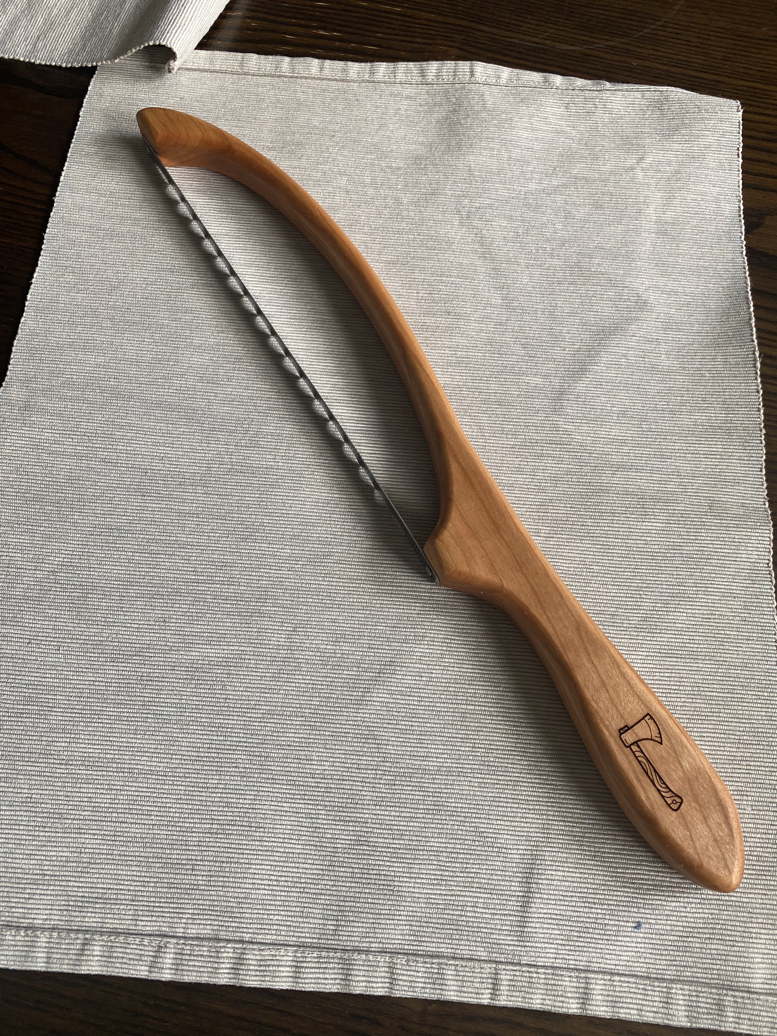 Handmade bread knife with custom wooden handle, artisan serrated bread knife designed for slicing bread and sourdough.