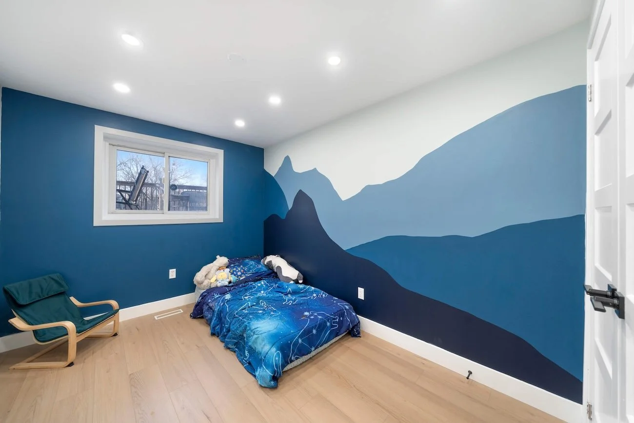 Kids bedroom with custom mountain wall mural in Oshawa basement renovation