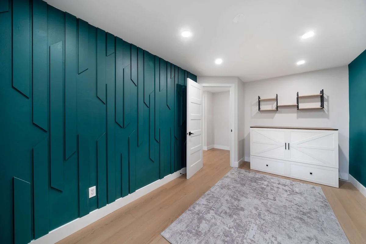 Modern basement home office with accent wall and storage in Oshawa renovation