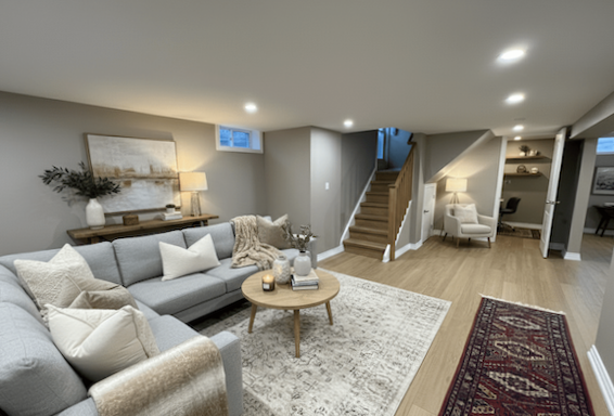 Finished basement living room in Whitby with modern flooring, recessed lighting, and an open, comfortable layout.