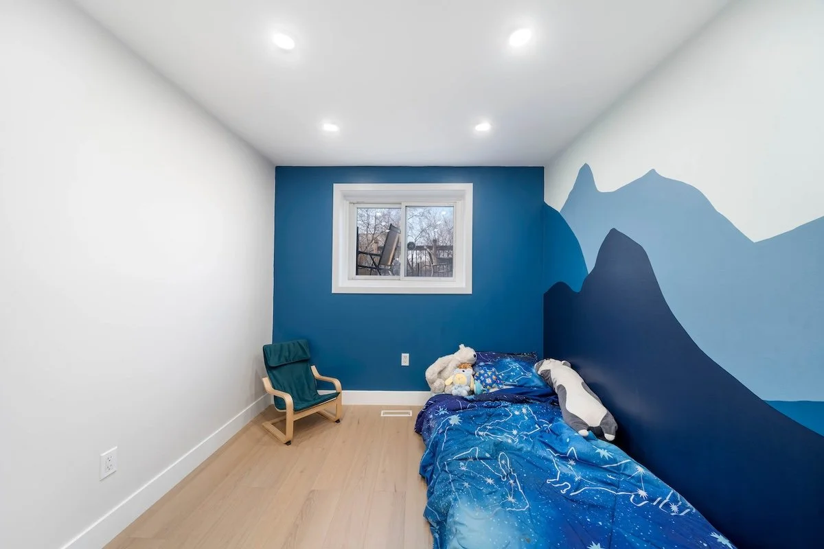 Kids bedroom design with mural of mountains wall art in basement renovation with modern finishes Oshawa