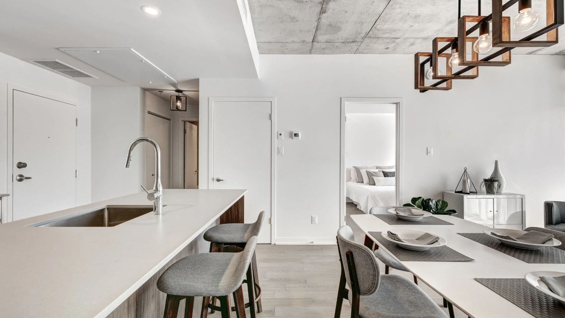 Modern pendant lighting over dining table in Oshawa condo renovation project