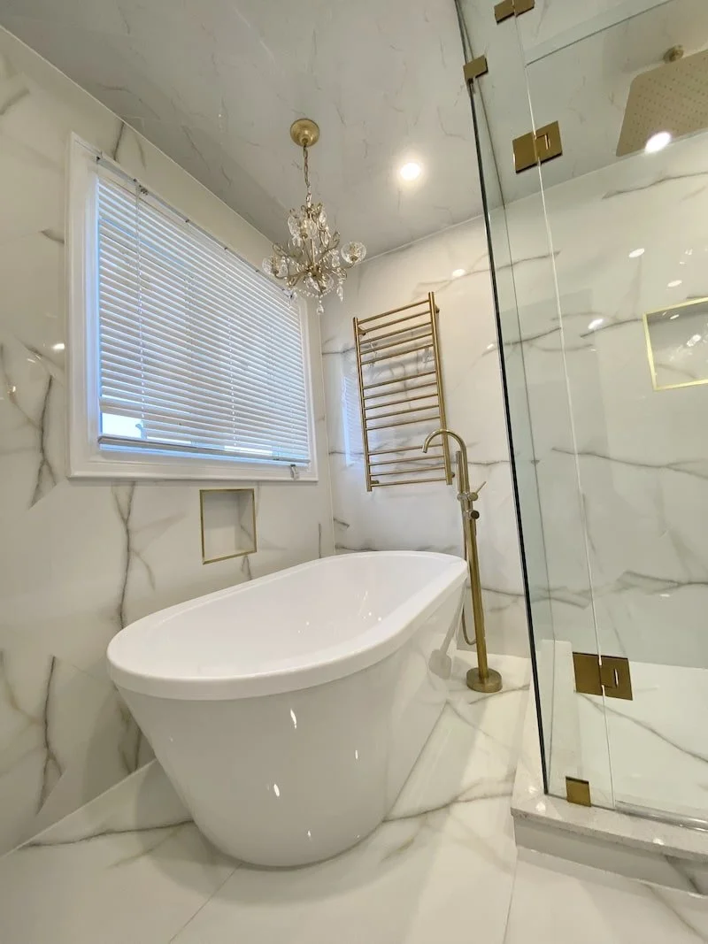 Custom geometric tile layout on bathroom walls showing symmetrical tile placement in a modern, high-end bathroom renovation project.
