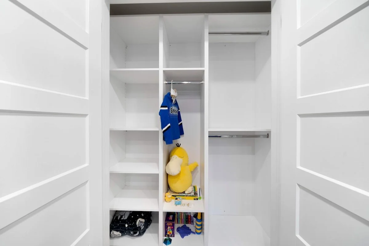 Closet hanging section with organized storage in custom basement renovation Oshawa