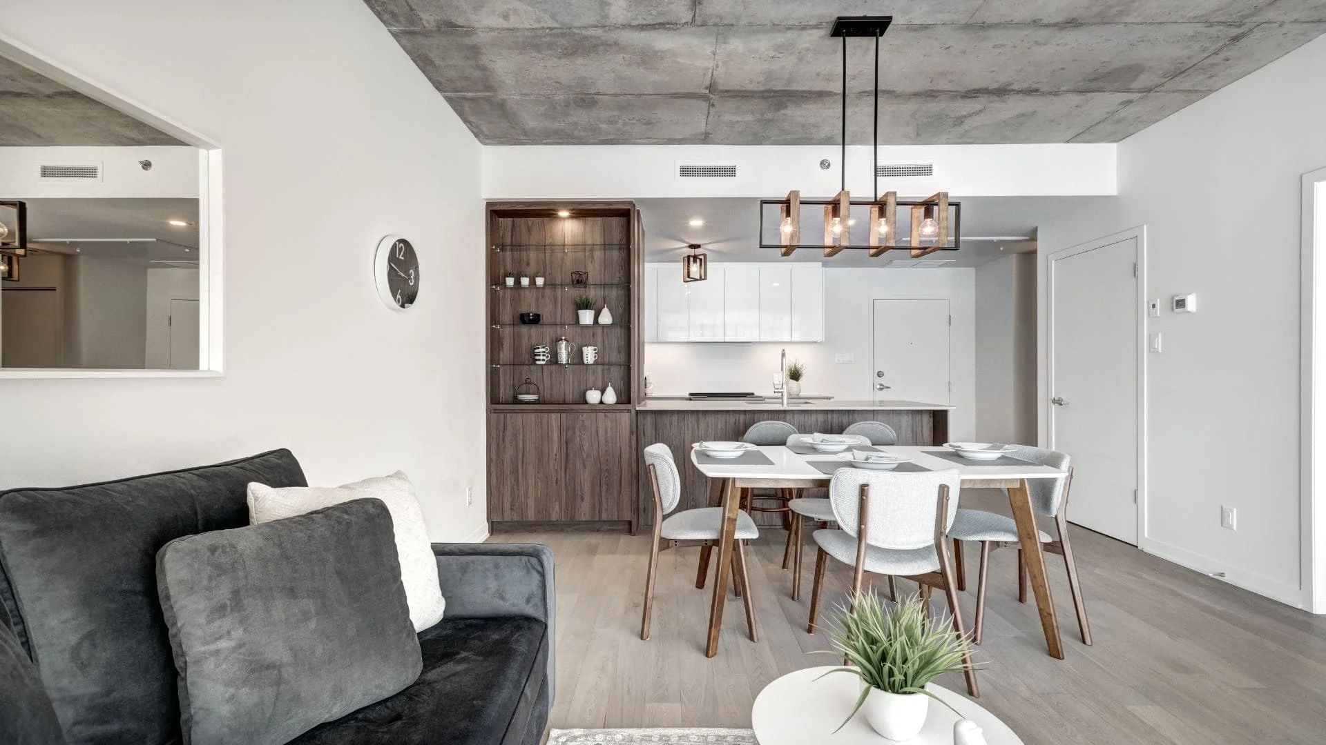 Two-tone kitchen design with wood pantry wall and white cabinetry in Oshawa condo