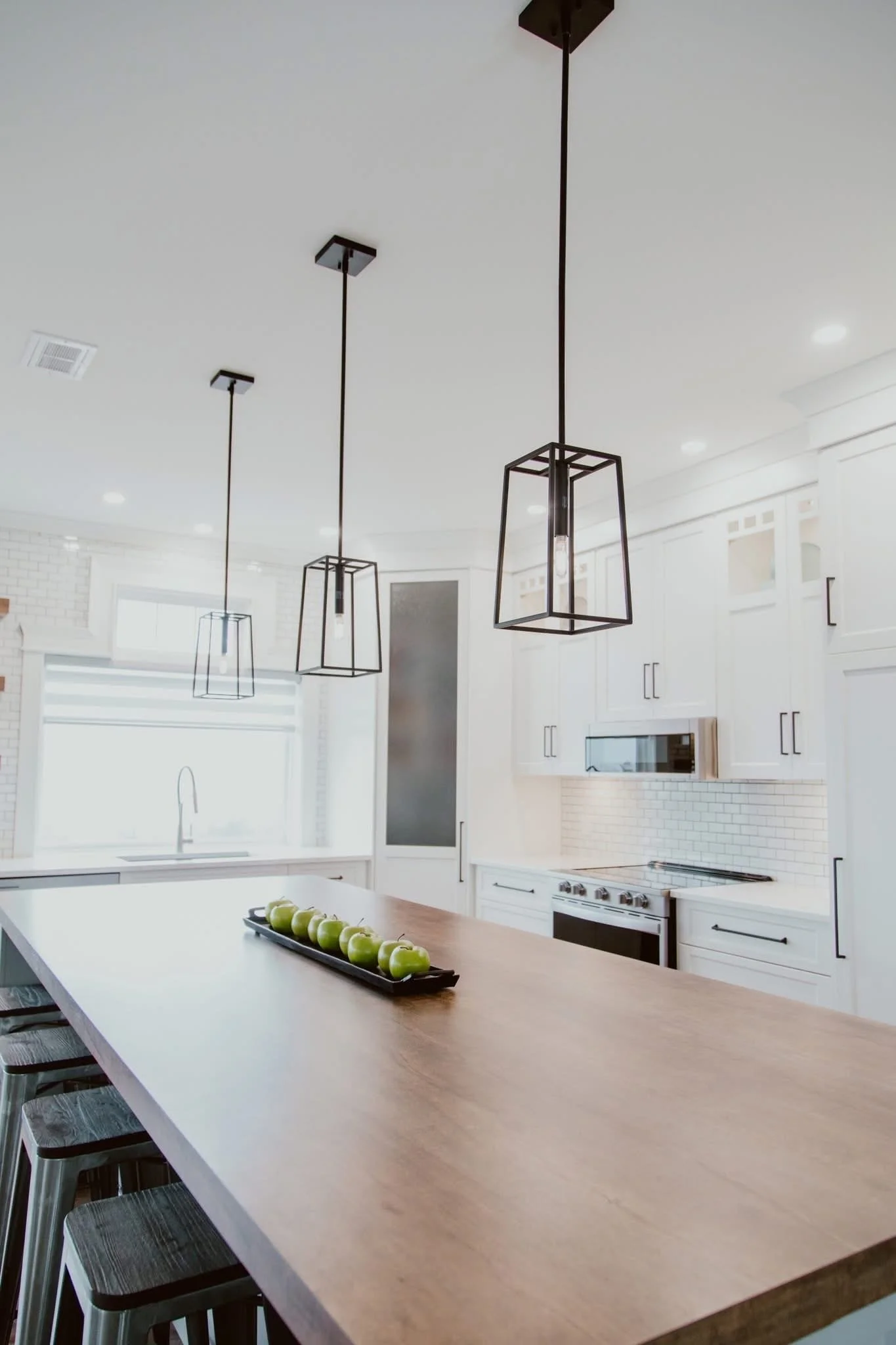 Modern open concept kitchen layout created after load bearing wall removal in a Durham Region home renovation.