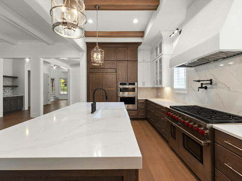 Renovated open-concept kitchen featuring updated cabinetry, flooring, and contemporary finishes