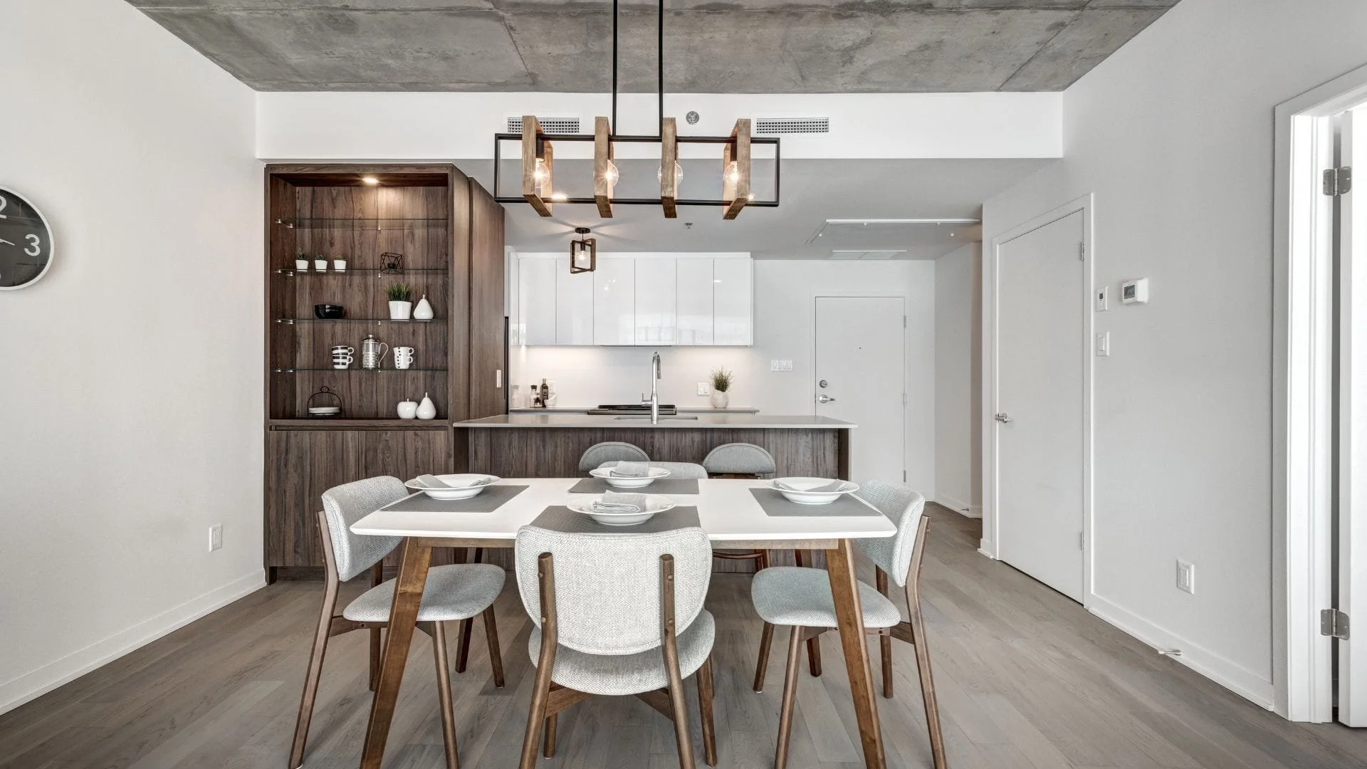 Modern condo renovation in Oshawa featuring open-concept kitchen and dining area with wood island and quartz countertop
