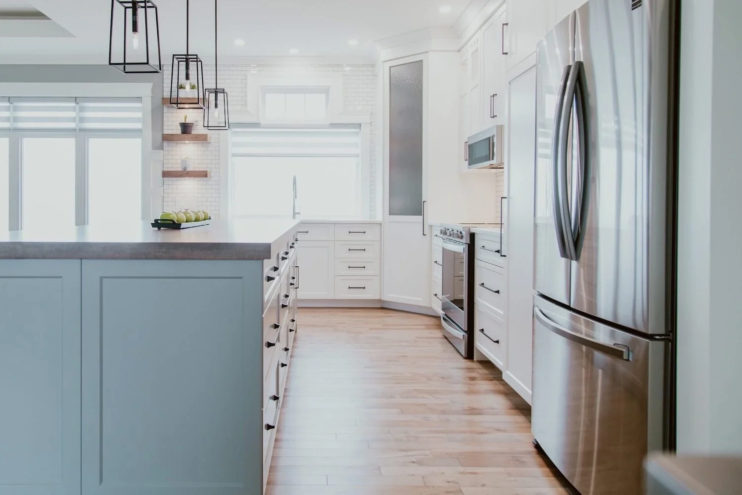 Open concept main floor renovation featuring a custom kitchen with quartz countertops and large island completed in Durham Region.