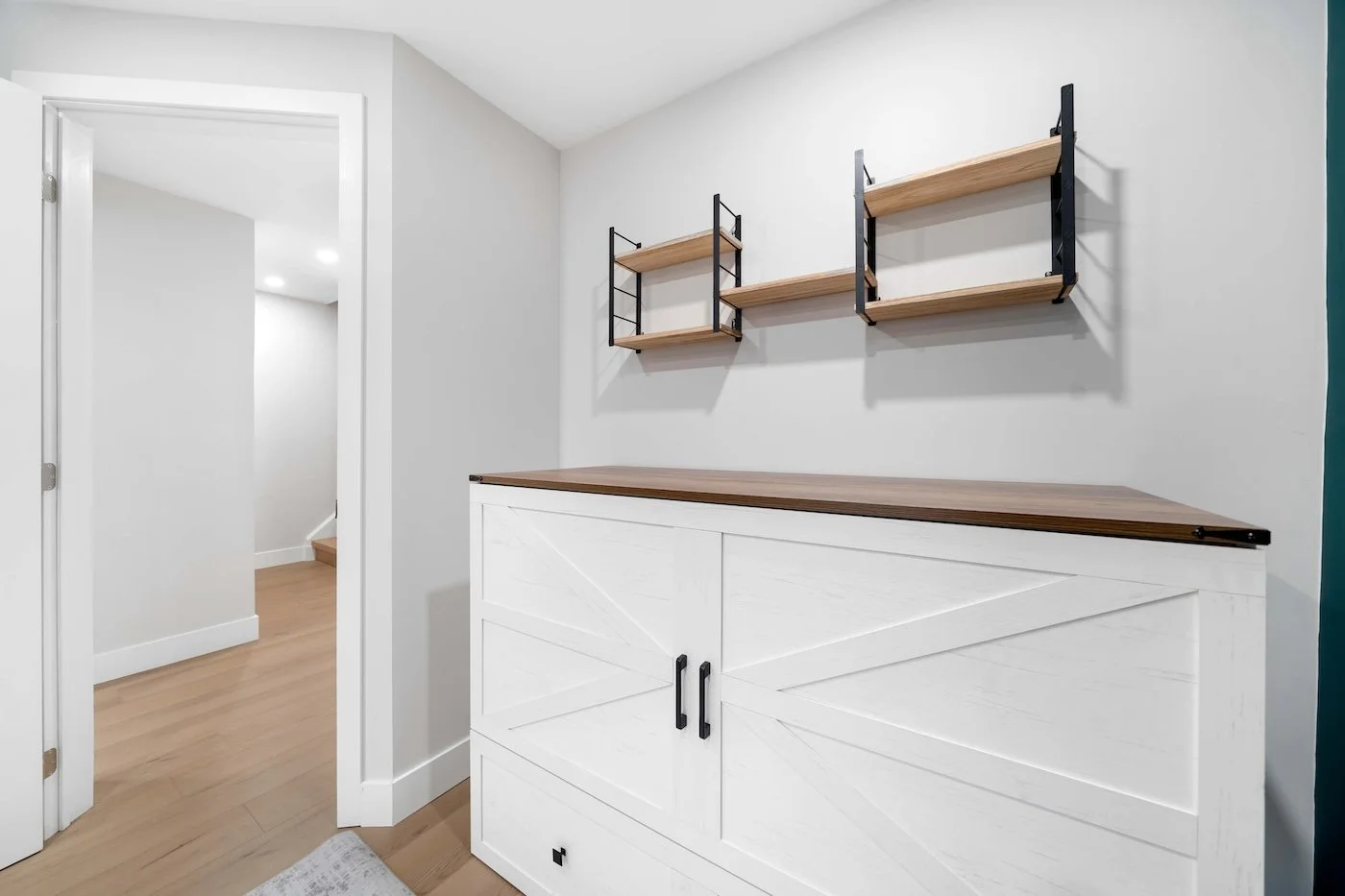 Custom closet with French doors and modern hardware in basement renovation Oshawa