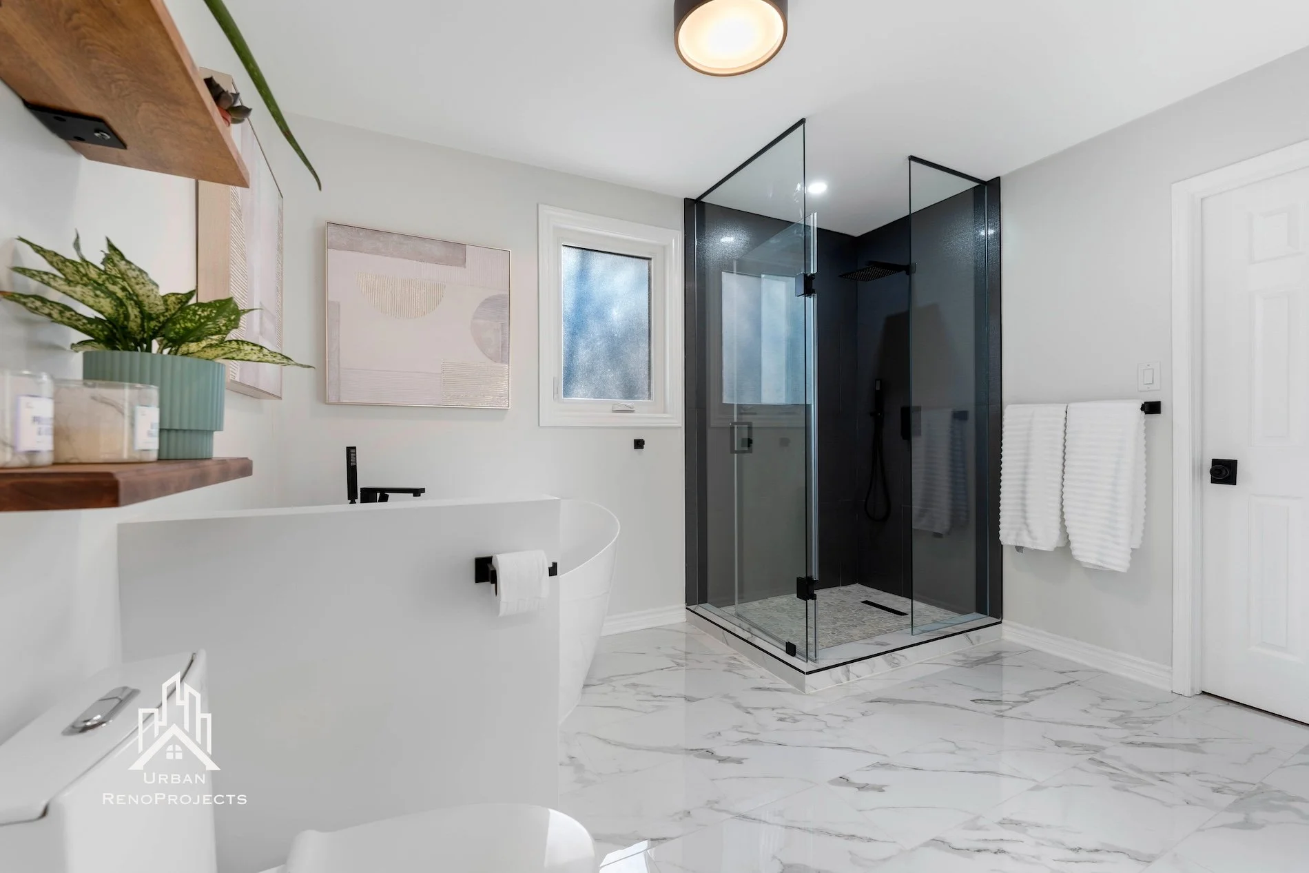 Luxury shower with frameless glass door and pebble flooring for added texture