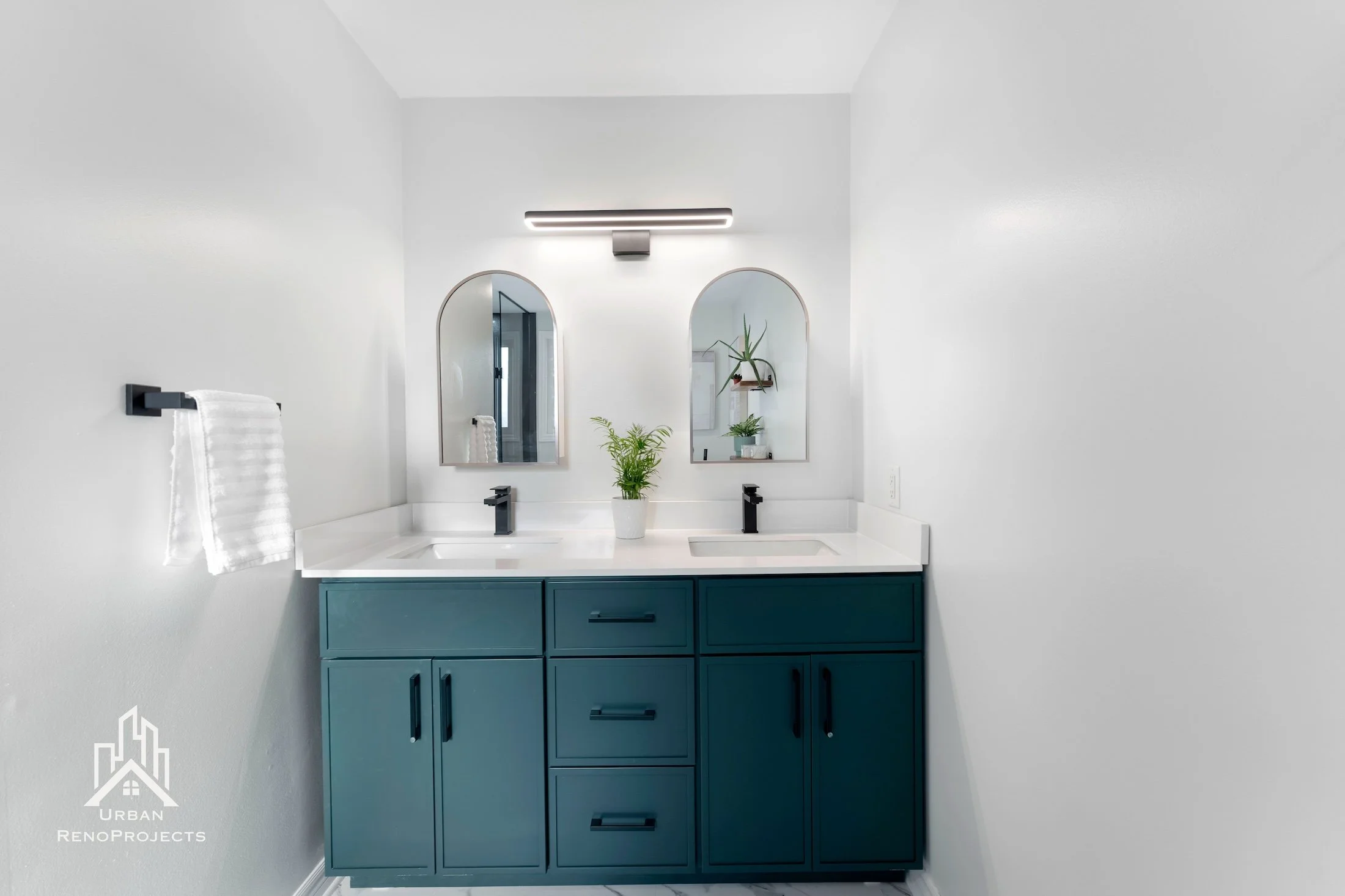 Contrasting tile design featuring Green his and her vanity with matt black finish and framed mirror