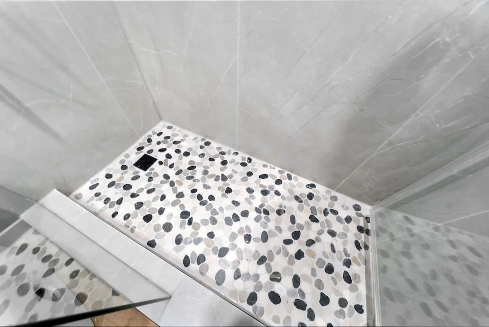 basement renovation in oshawa with shower pebble floor detail.jpg