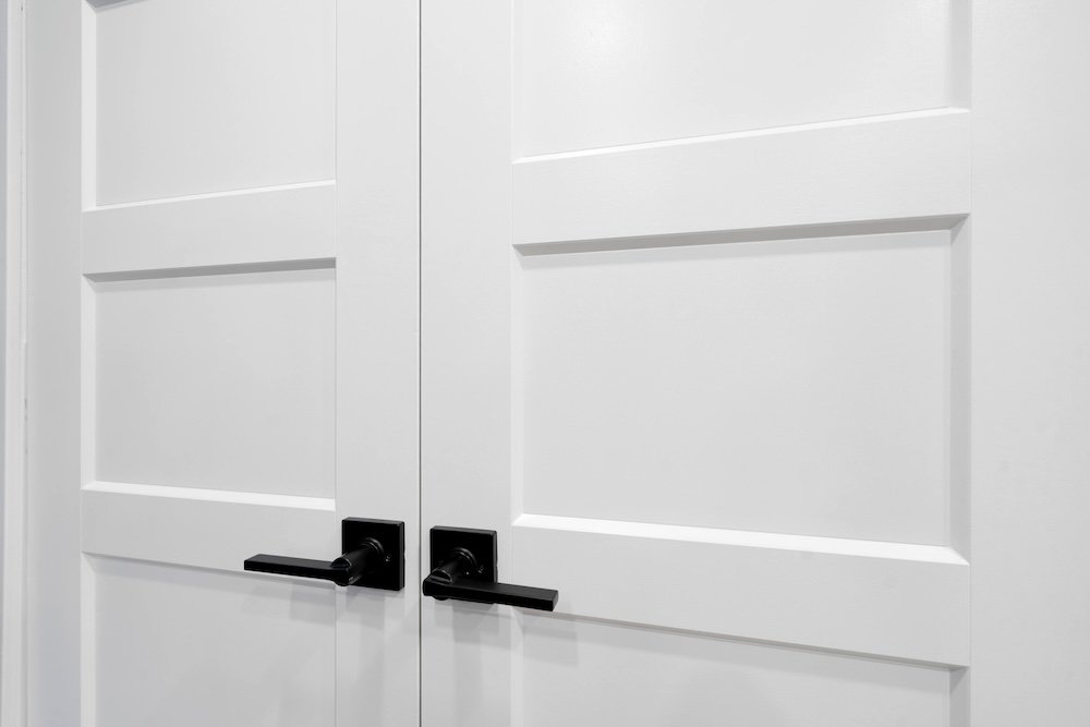 Detailed view of french door of custom closet organizer with shelving and hanging space Oshawa basement