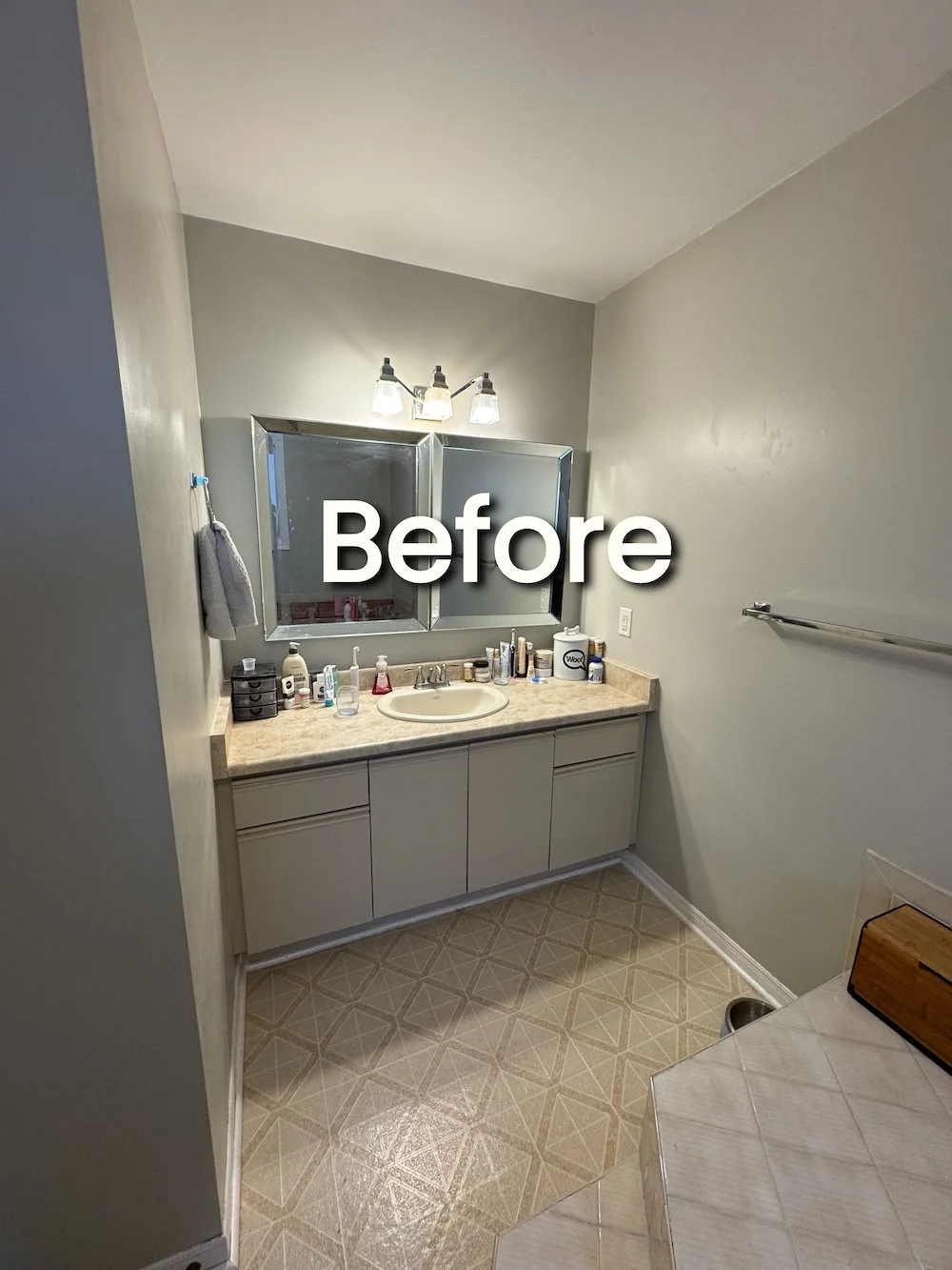 Outdated master bathroom with single dated vanity and corner tub
