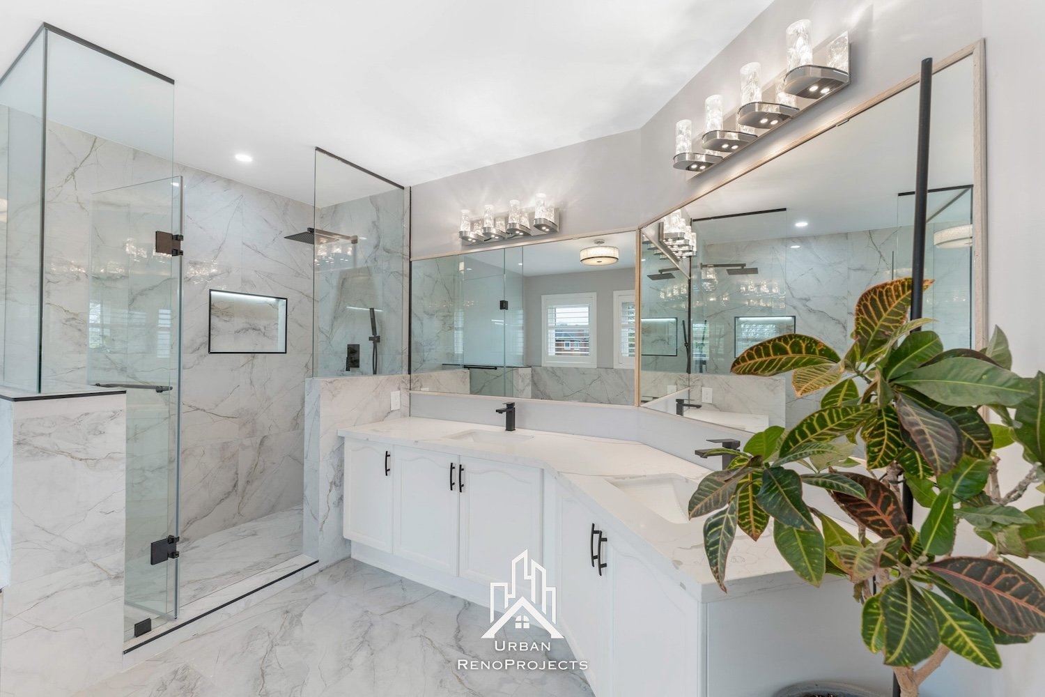 Newly renovated master bathroom in Durham, Ontario. Enjoy the walk-in shower, elegant half-tile walls, illuminated LED niche, and contemporary matte black fixtures.