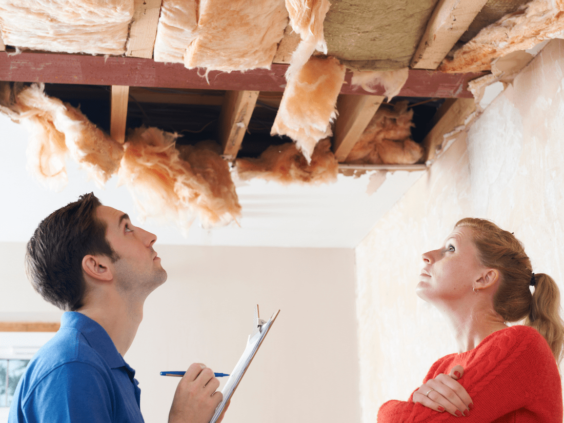 Professional & homeowner Inspecting Roof Damage