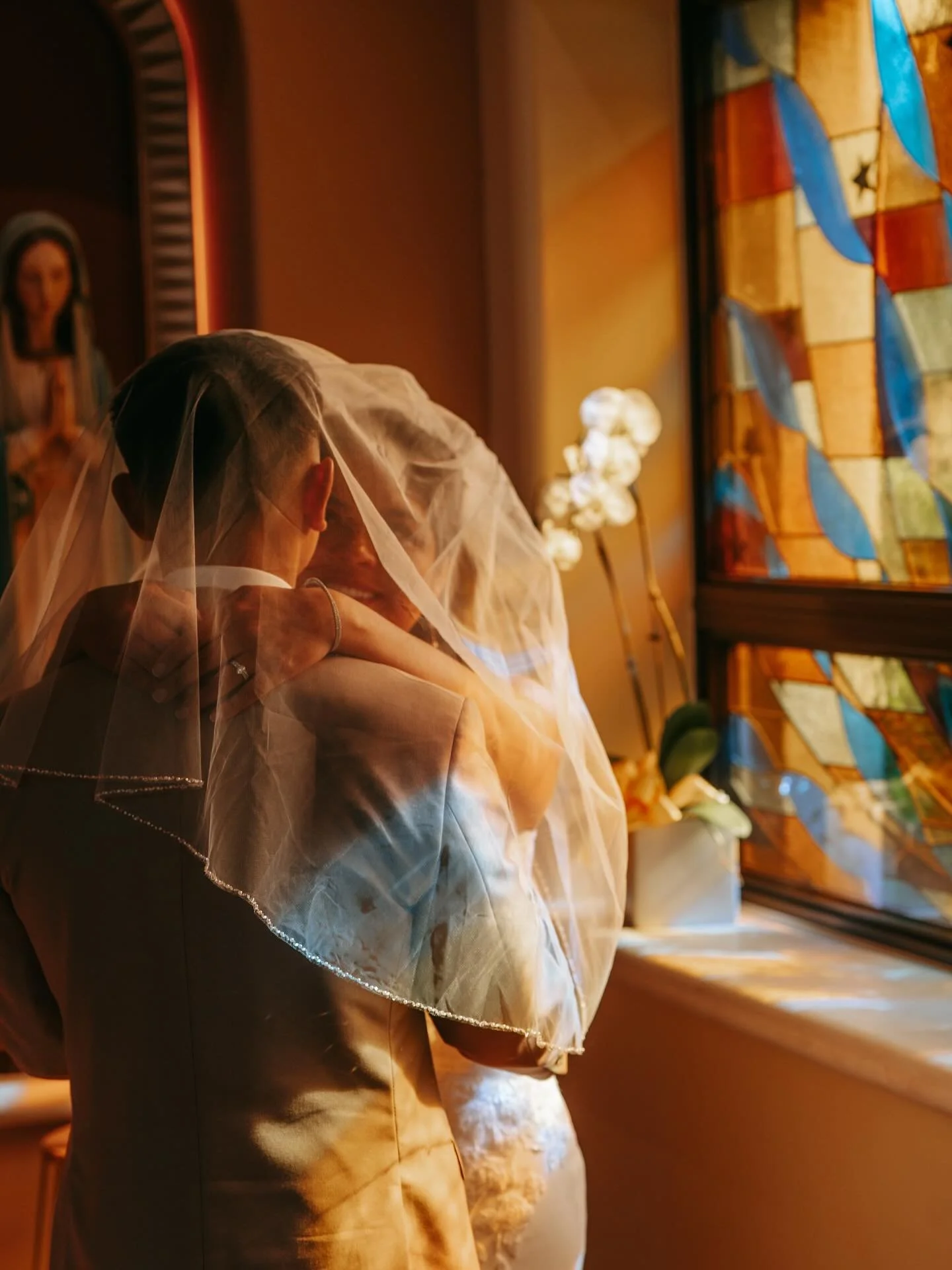 The way the light filtered through the stained glass and cast rainbows all around J + A felt like God&rsquo;s own blessing poured out in color. Stained glass has this beautiful way of taking ordinary light and turning it into something holy&hellip; k