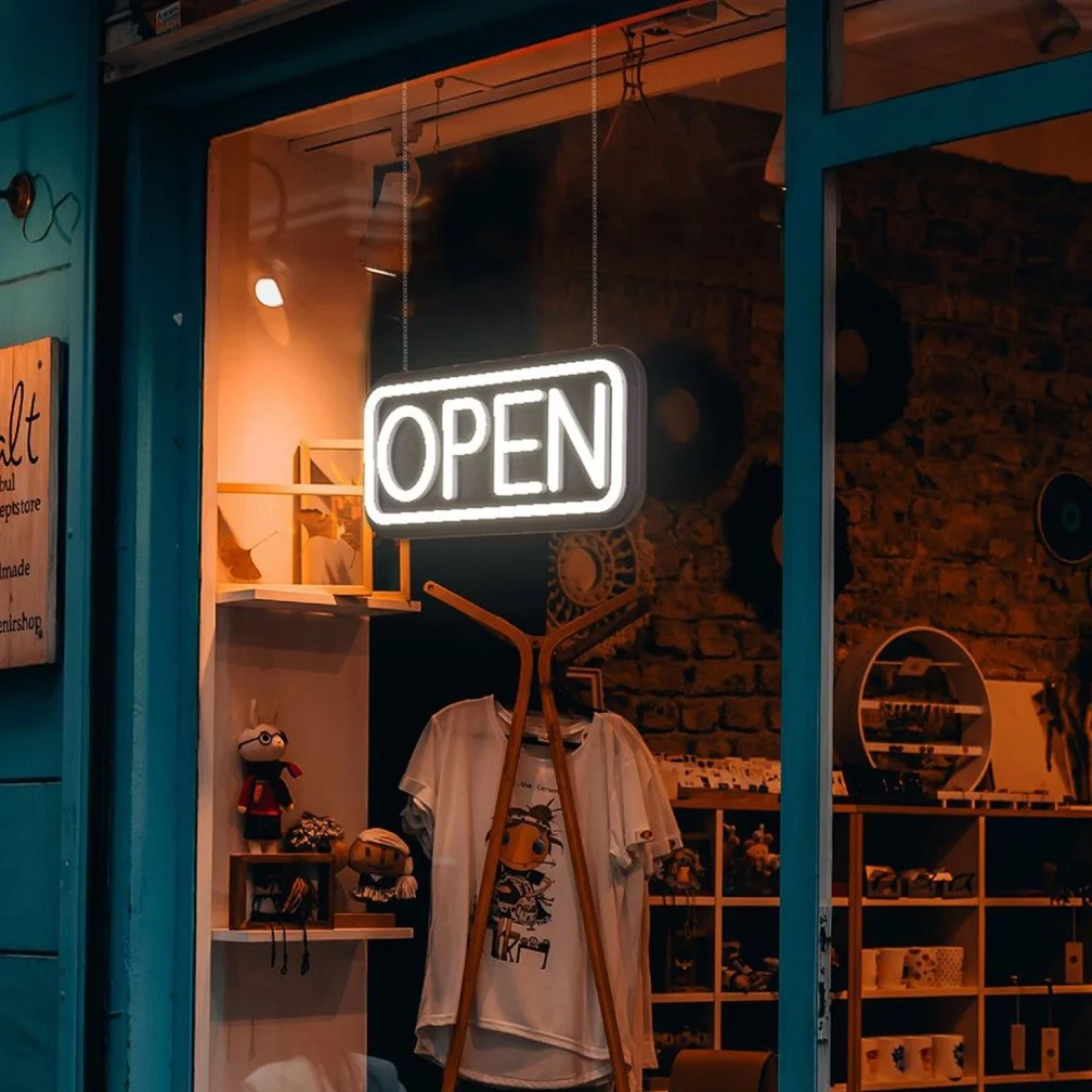 LED neon sign on a store window says open
