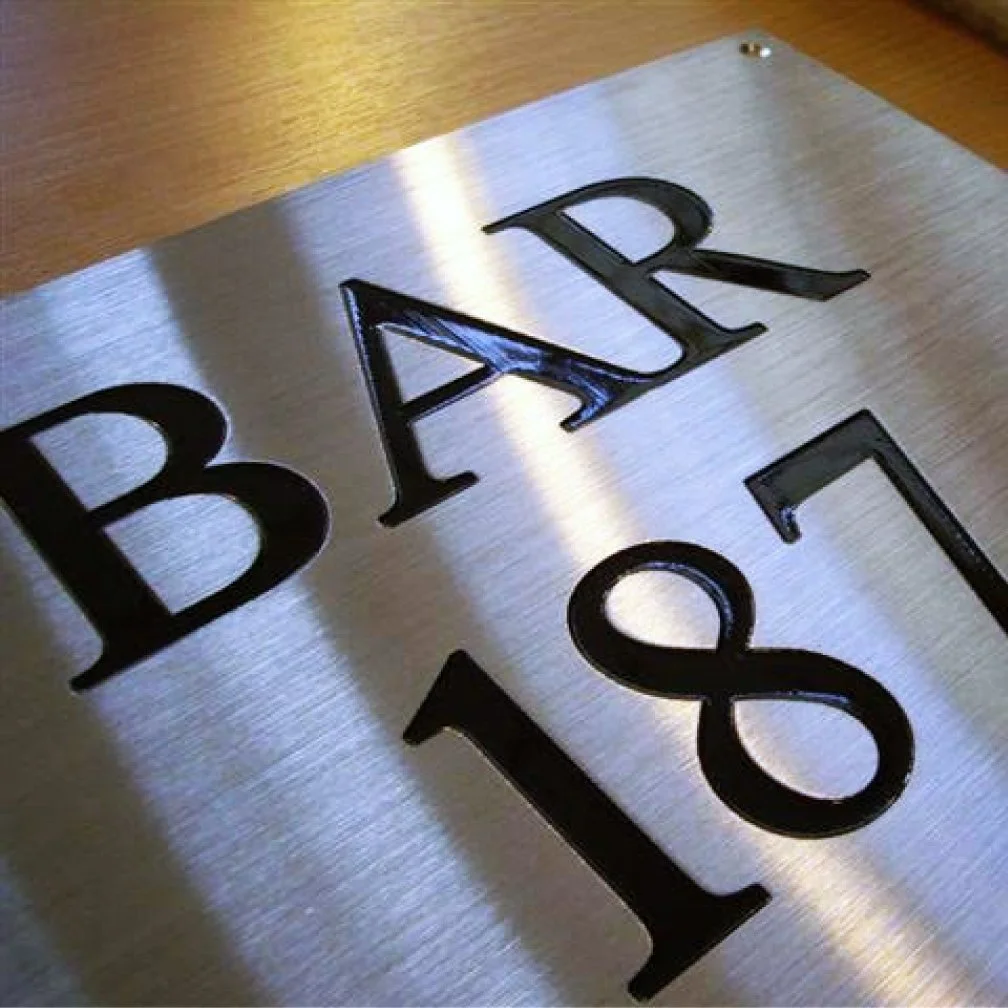 Image of aluminum engraved sign with black ink letters