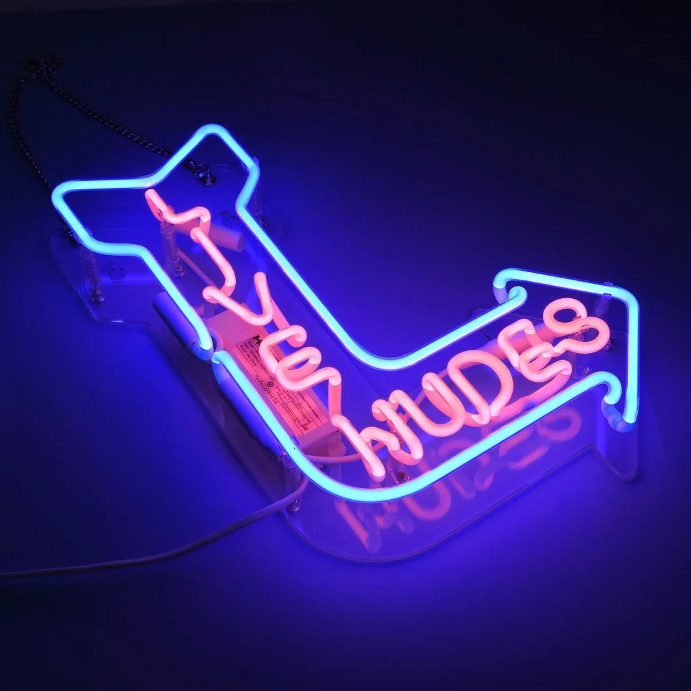 image shows neon sign arrow with pink and blue colors of neon